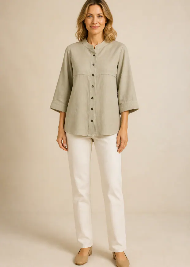 Woman wearing a khaki mandarin-collar linen shirt with white trousers